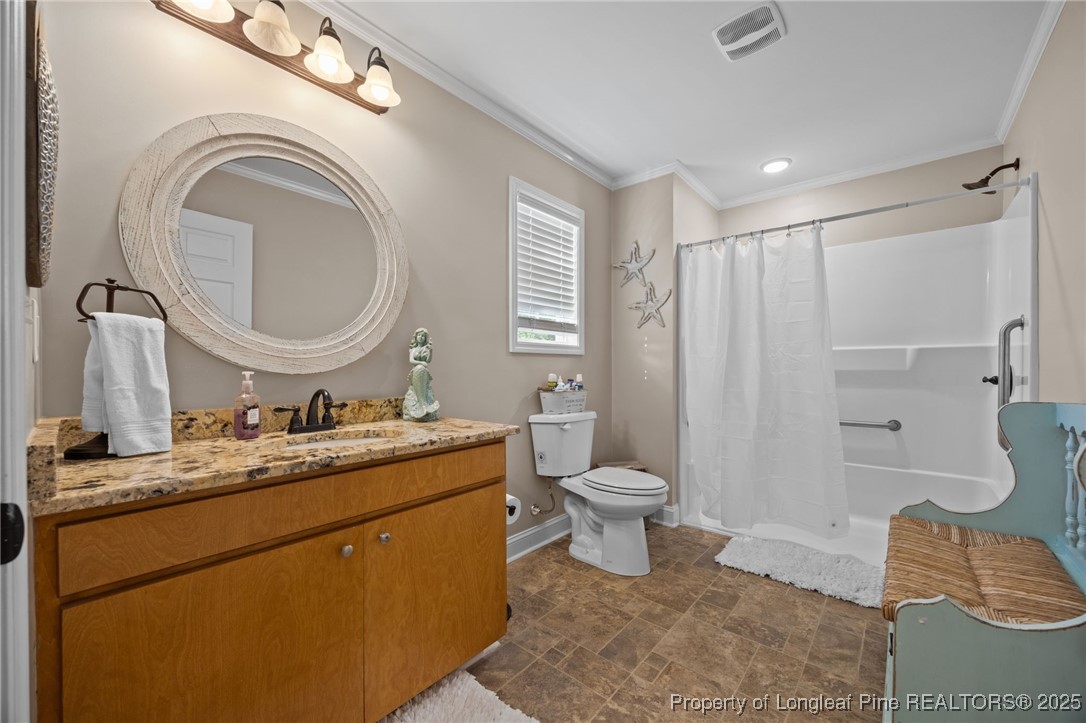 262 River Birch Run Coats, NC 27521 - Photo 14 of 49 a bathroom with a toilet sink vanity granite and a mirror
