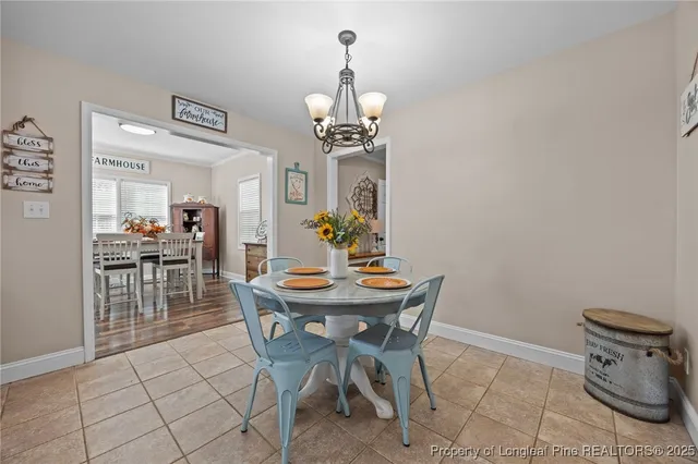 a view of a dining room with furniture and chandelier