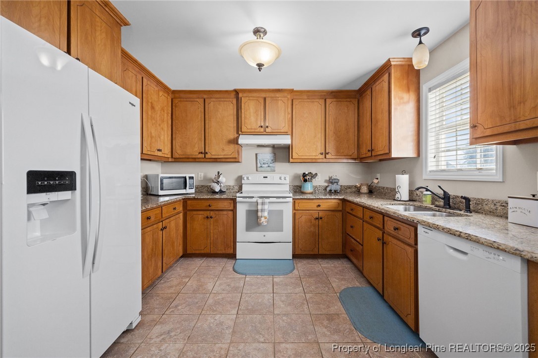 262 River Birch Run Coats, NC 27521 - Photo 23 of 49 a kitchen with a stove top oven sink and cabinets