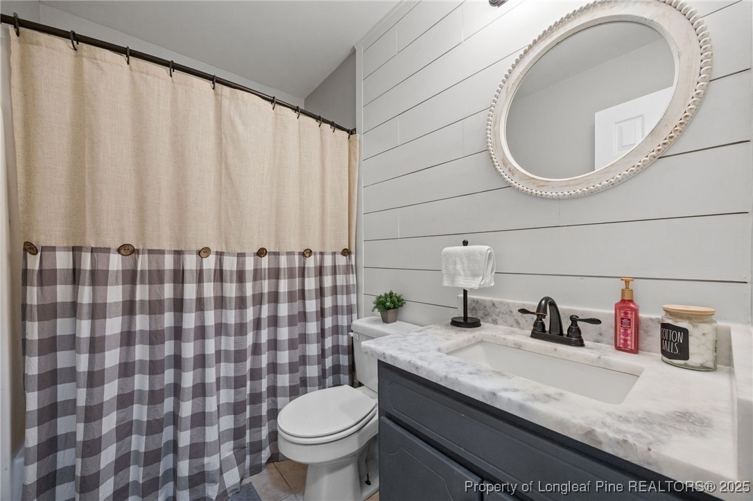 262 River Birch Run Coats, NC 27521 - Photo 34 of 49 a bathroom with a granite countertop sink and a mirror