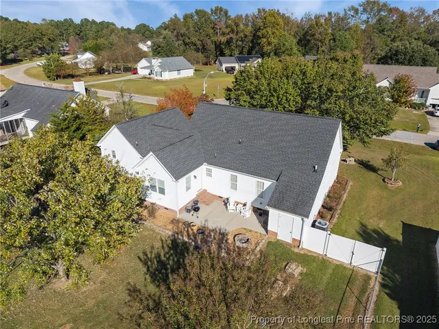 an aerial view of residential houses with outdoor space and river