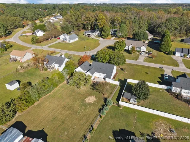 an aerial view of a house with a swimming pool