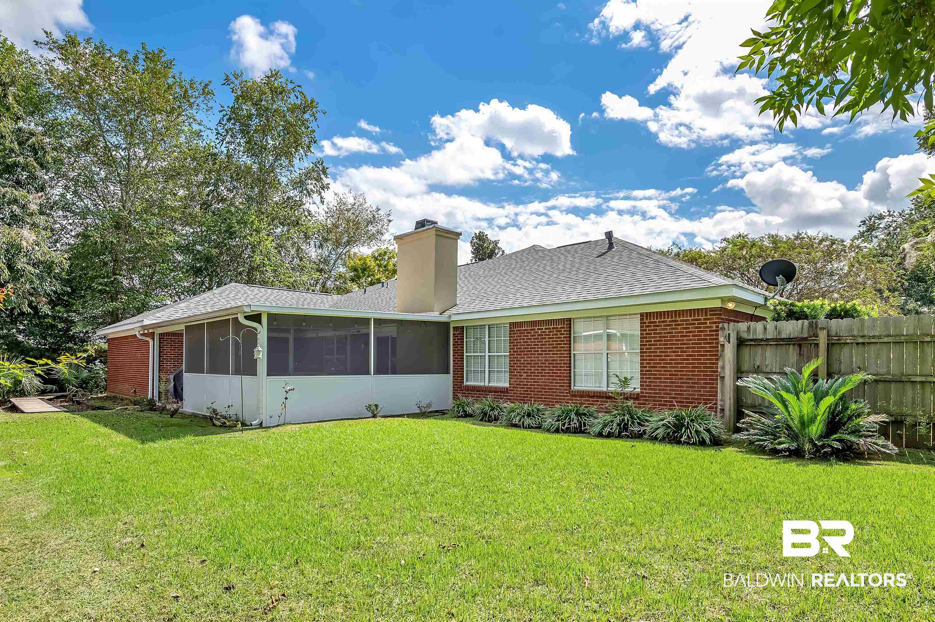 9901 Glover Court Fairhope, AL 36532 - Photo 51 of 52 Rear view of property featuring a sunroom and a yard