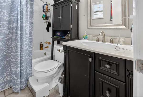 a bathroom with a sink toilet and mirror