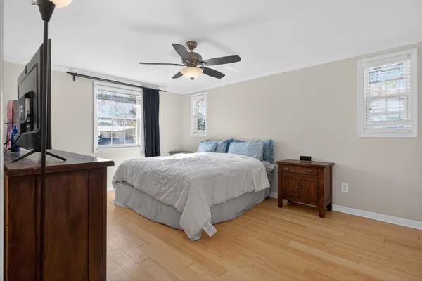 a spacious bedroom with a bed and a dresser