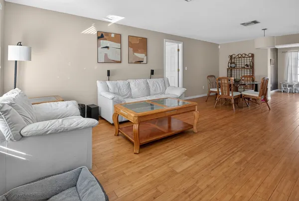 a living room with furniture and a wooden floor