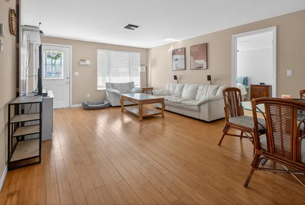 a view of a dining room with furniture and wooden floor