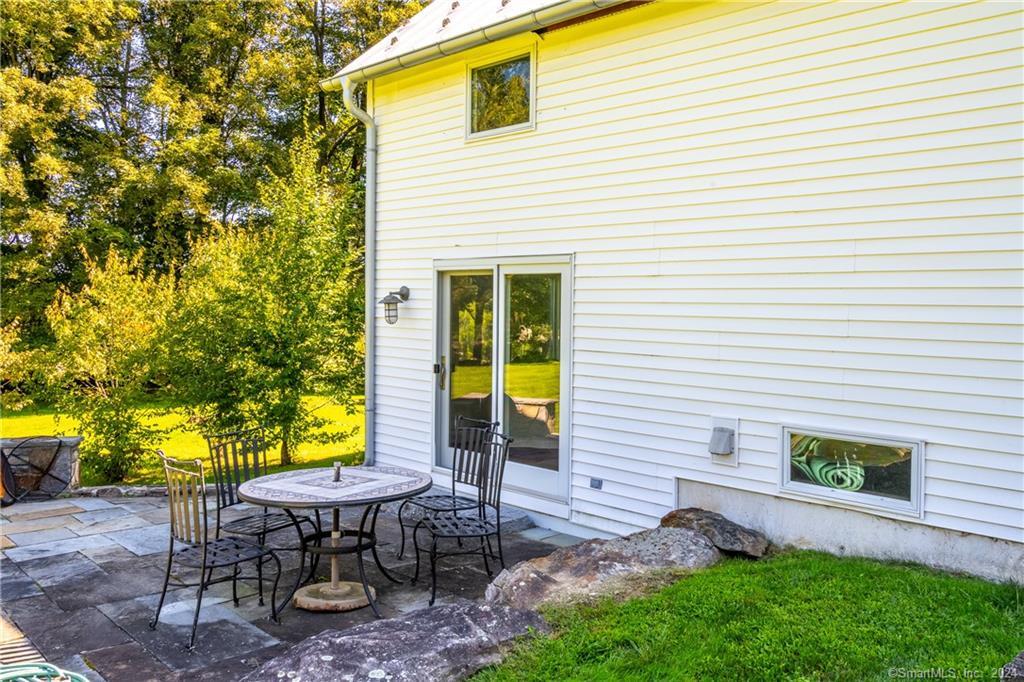 35 Jennings Road Kent, CT 06785 - Photo 18 of 20 a backyard of a house with table and chairs