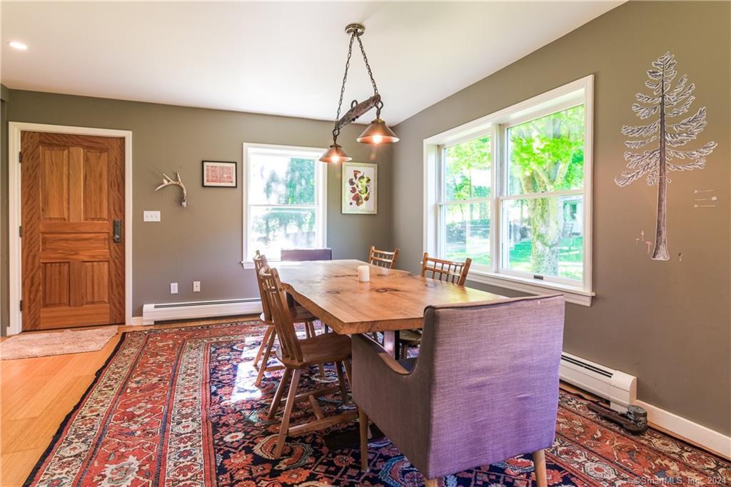 35 Jennings Road Kent, CT 06785 - Photo 3 of 20 a dining room with wooden floor a chandelier a wooden table and chairs