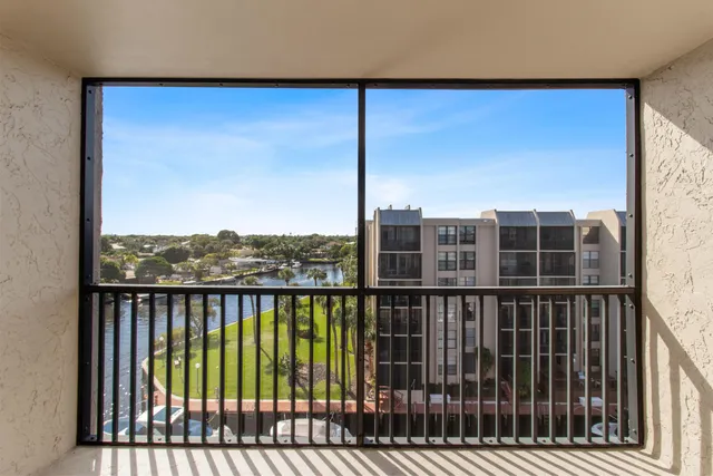 a view of a balcony with floor to ceiling window and wooden floor