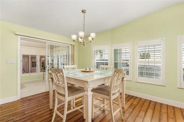 a view of a dining room with furniture wooden floor and chandelier