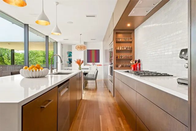 a kitchen with stainless steel appliances kitchen island granite countertop a sink and cabinets
