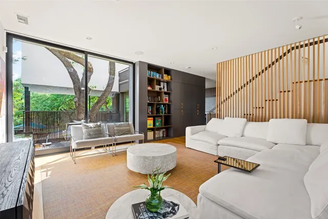 a living room with furniture and a book shelf