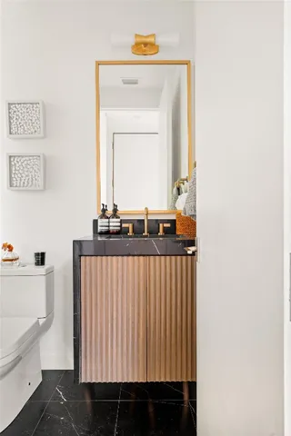 a bedroom with a large bed and a flat tv screen on dresser