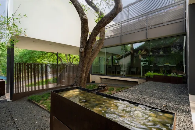 a dining room with furniture and a floor to ceiling window