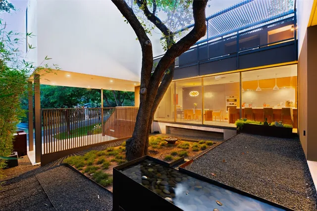 an aerial view of lake and residential houses with outdoor space