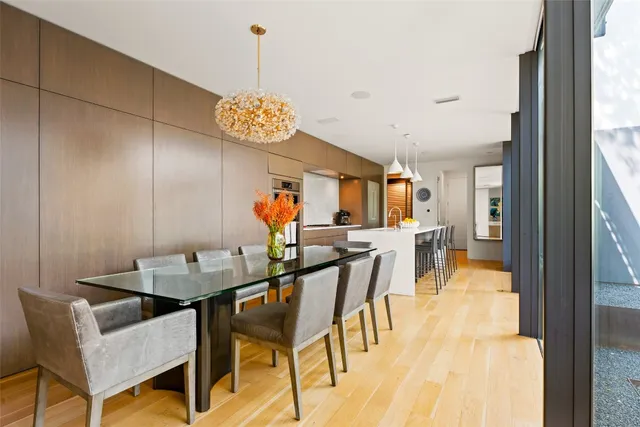 a view of a dining room with furniture and a chandelier