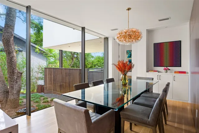 a view of a dining room with furniture wooden floor and chandelier