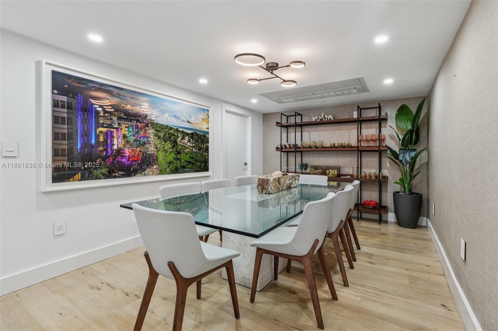 102 24th Street, Unit 1440 Miami Beach, FL 33139 - Photo 15 of 78 a view of a dining room with furniture wooden floor and a rug