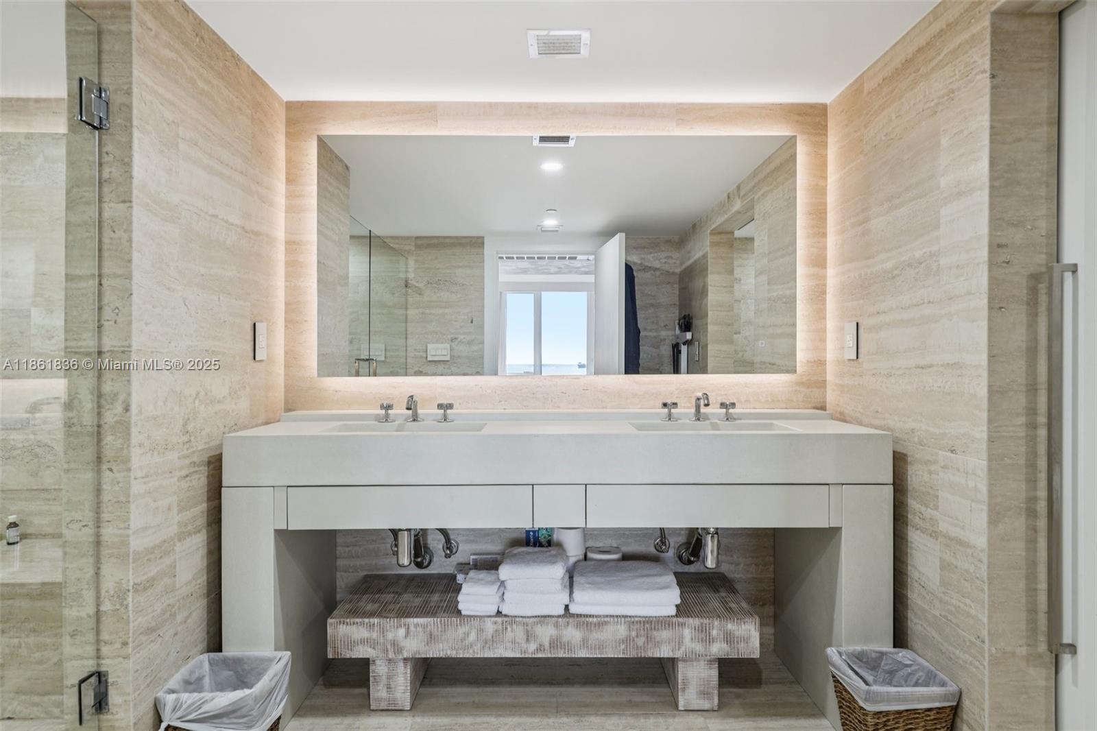 102 24th Street, Unit 1440 Miami Beach, FL 33139 - Photo 24 of 78 a bathroom with a sink and a mirror