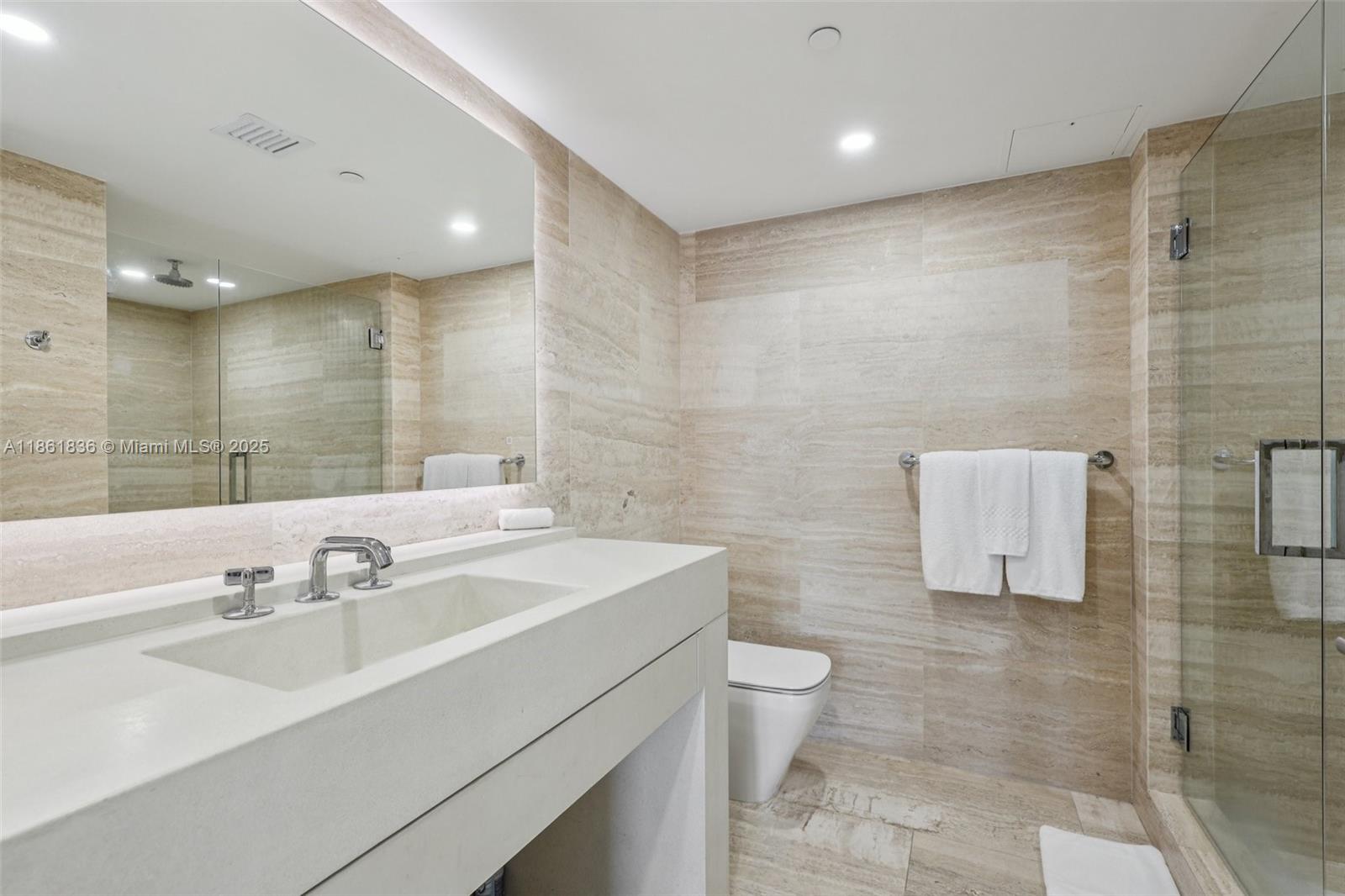 102 24th Street, Unit 1440 Miami Beach, FL 33139 - Photo 39 of 78 a bathroom with a sink a toilet and mirror