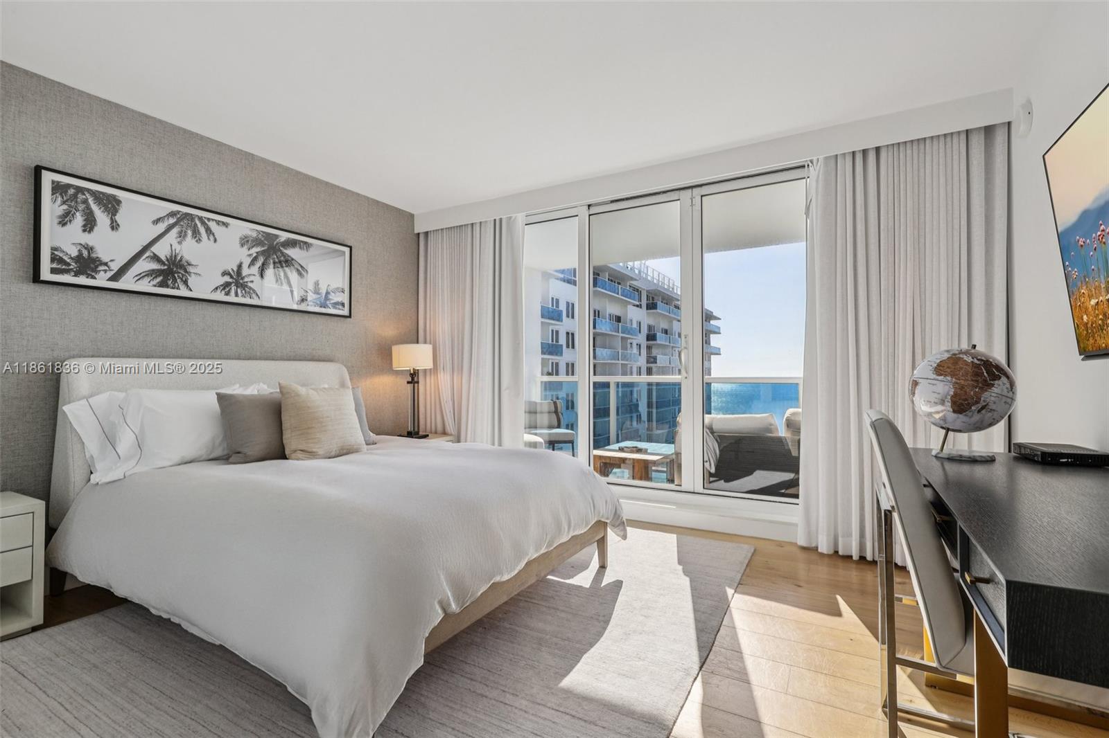 102 24th Street, Unit 1440 Miami Beach, FL 33139 - Photo 41 of 78 a bedroom with a large bed and a large window