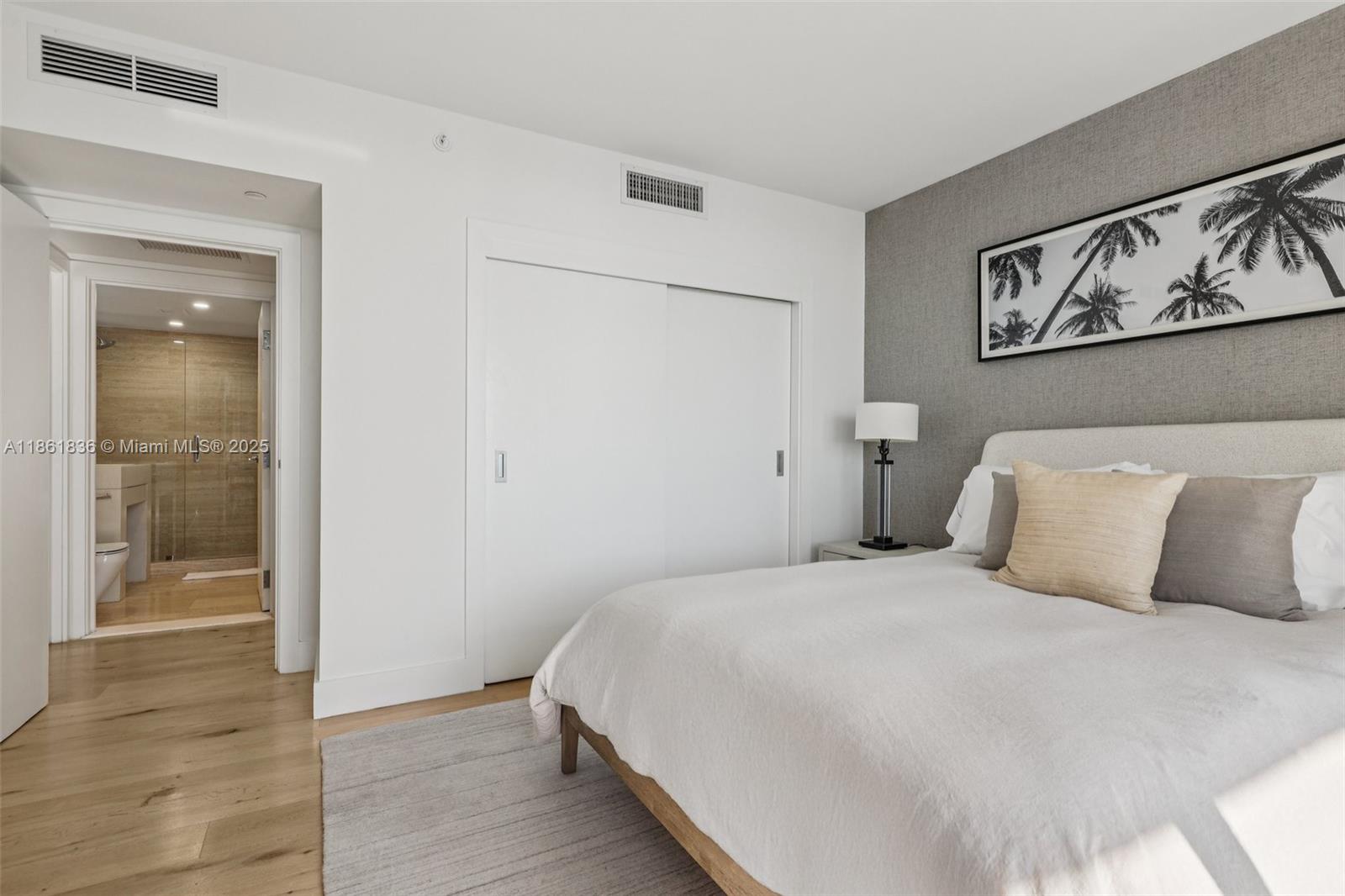 102 24th Street, Unit 1440 Miami Beach, FL 33139 - Photo 43 of 78 a bedroom with a large bed and a window