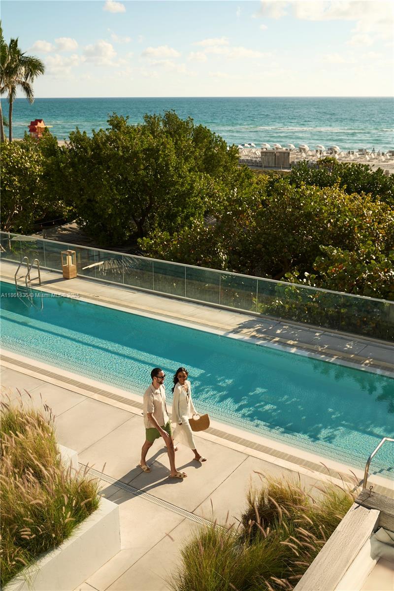 102 24th Street, Unit 1440 Miami Beach, FL 33139 - Photo 67 of 78 a view of a swimming pool with a yard