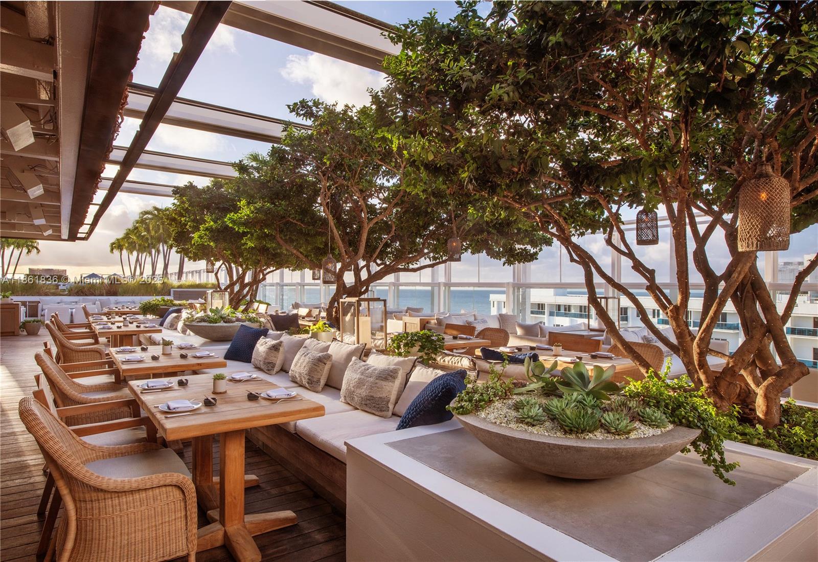102 24th Street, Unit 1440 Miami Beach, FL 33139 - Photo 77 of 78 a view of a terrace with furniture and potted plants