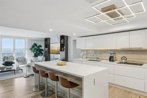 a kitchen with stainless steel appliances a refrigerator and a sink