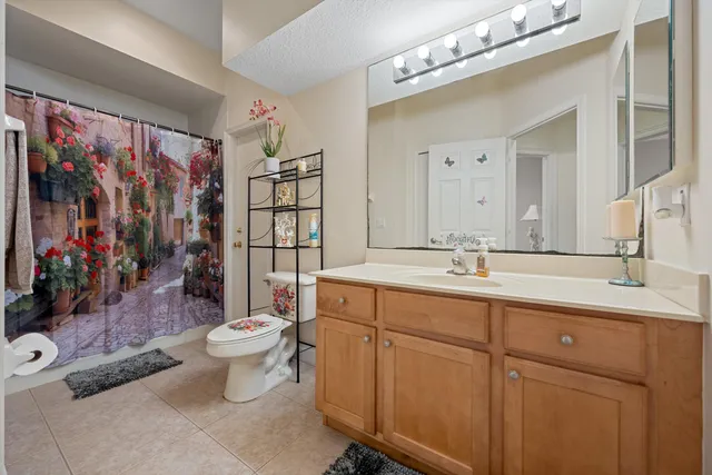 a bathroom with a double vanity sink mirror and toilet