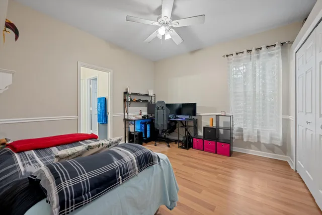 a bedroom with bed and a chandelier