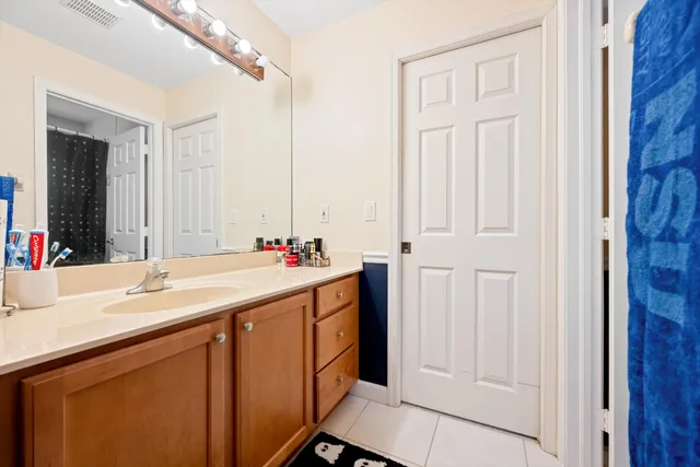 a bathroom with a double vanity sink and a mirror