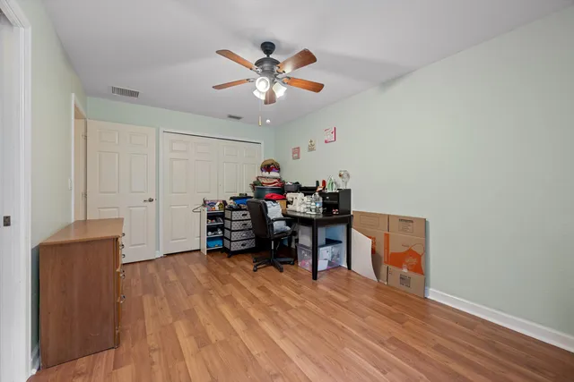 a view of a workspace with furniture and a chandelier fan