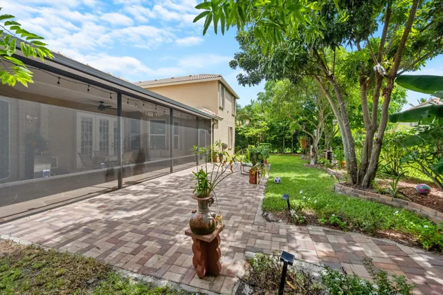 a green field with trees in front of it