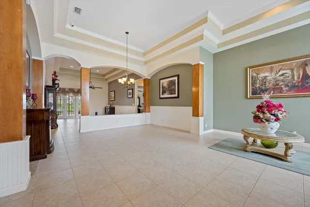 a living room with furniture and a chandelier