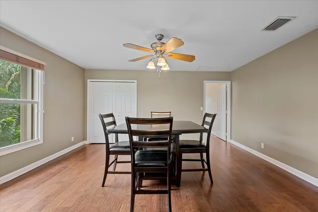 a view of a dining room with furniture and a window