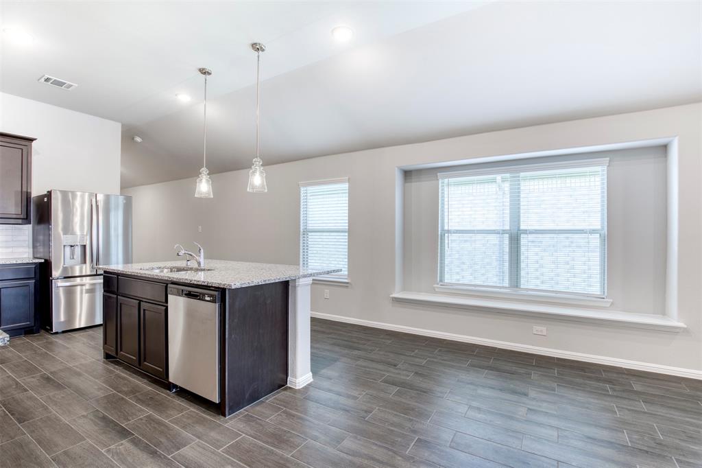 7108 Calshot Road Pilot Point, TX 76258 - Photo 11 of 28 Kitchen opens to breakfast area.