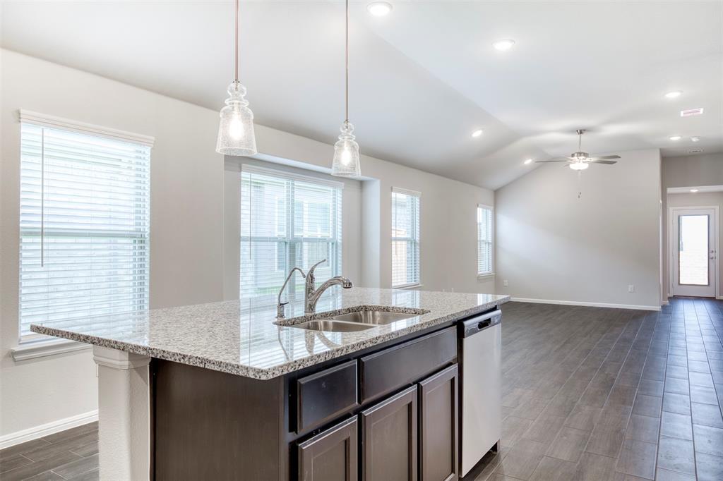 7108 Calshot Road Pilot Point, TX 76258 - Photo 13 of 28 Kitchen with large eat-in island with pendant lighting.