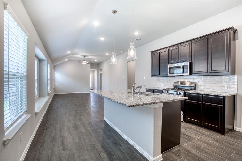 7108 Calshot Road Pilot Point, TX 76258 - Photo 14 of 28 Kitchen flows seamlessly to living room.