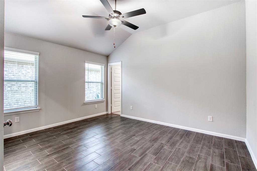 7108 Calshot Road Pilot Point, TX 76258 - Photo 17 of 28 Primary bedroom with sloped ceiling and ceiling fan.
