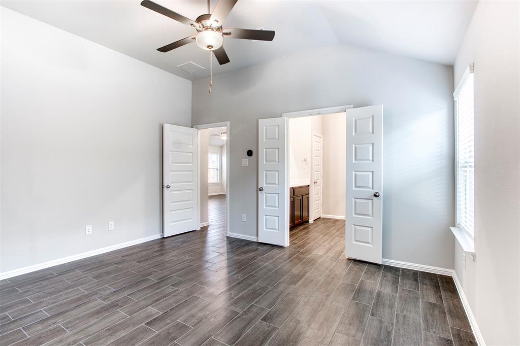 7108 Calshot Road Pilot Point, TX 76258 - Photo 18 of 28 Primary bedroom with double-door entry to en-suite bath.