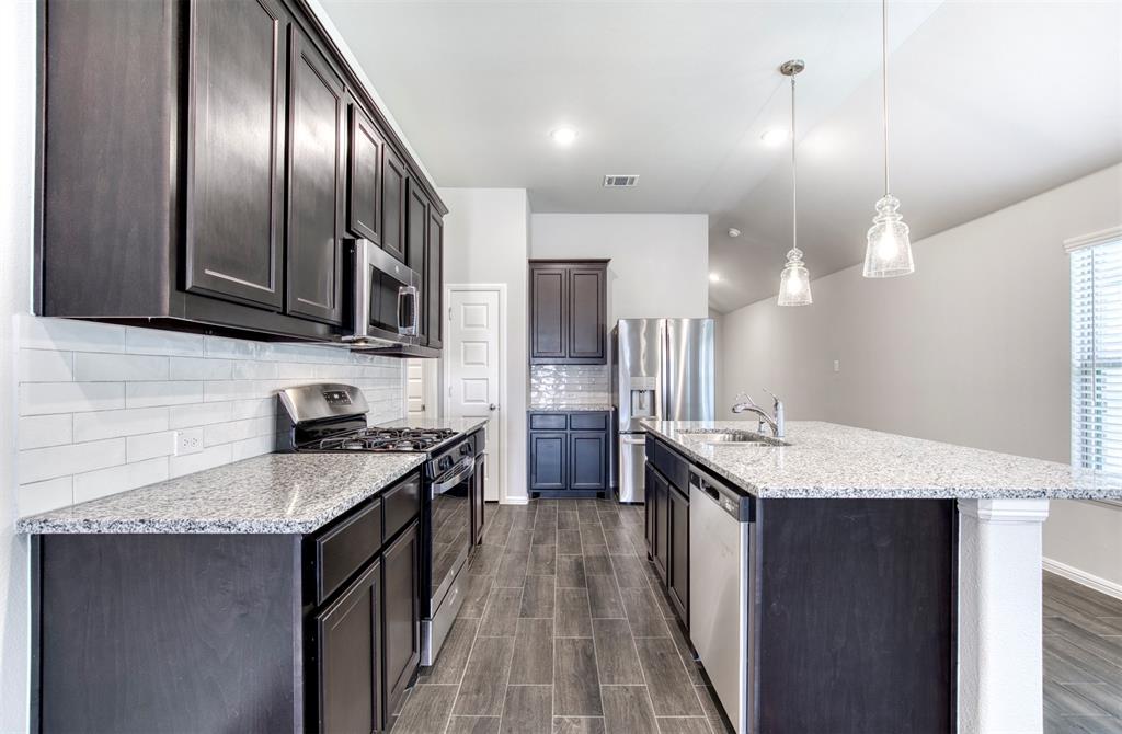 7108 Calshot Road Pilot Point, TX 76258 - Photo 10 of 28 Kitchen with subway backsplash and pantry.
