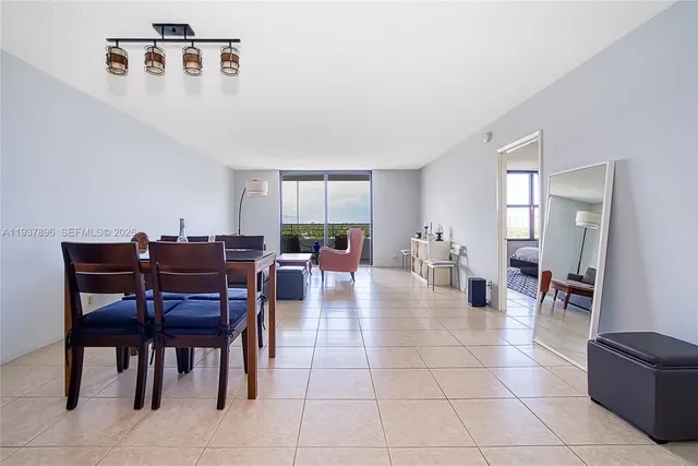 a living room with furniture and a floor to ceiling window
