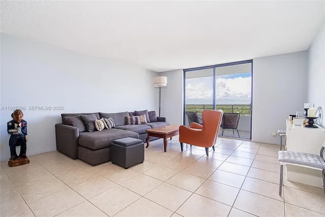 a living room with furniture and kitchen view
