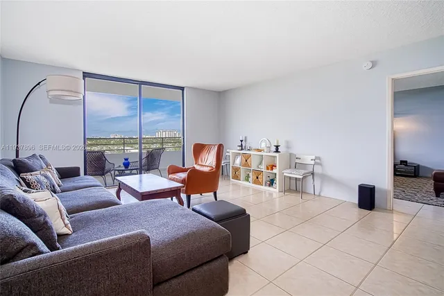 a living room with furniture a rug and a lamp