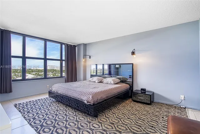 a bedroom with a large bed dresser and a window