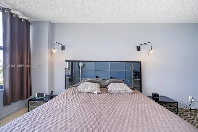 a view of a room that has a large window and front door