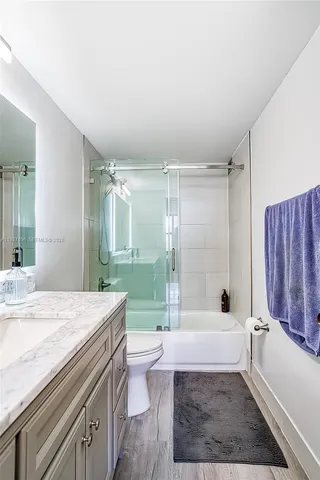 a bathroom with a sink a mirror and a shower