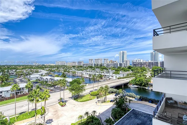 a view of swimming pool with outdoor seating and city view